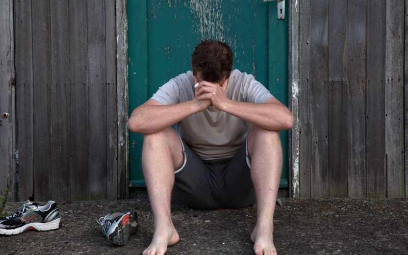 Person sitting peacefully outdoors, representing a reflective mental health moment