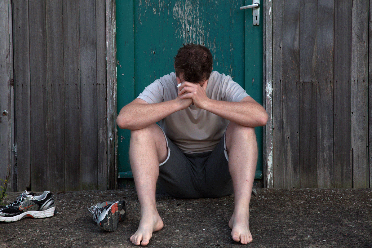 Person sitting peacefully outdoors, representing a reflective mental health moment